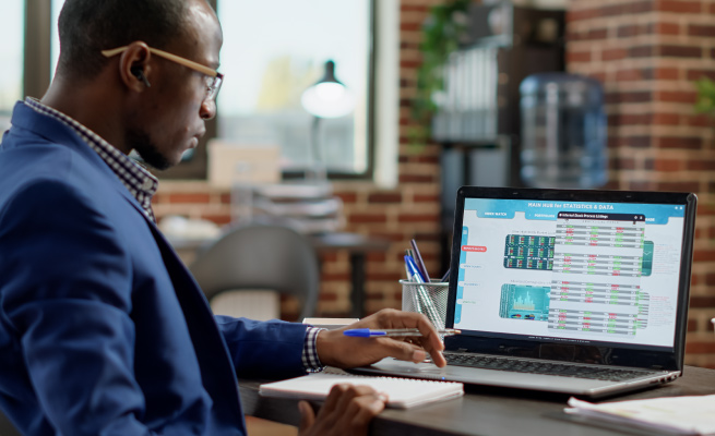 LuminCore Consulting's risk management expert engaged in a risk analysis and audit in their well-equipped office in Accra, Ghana. Offering tailored risk management services.